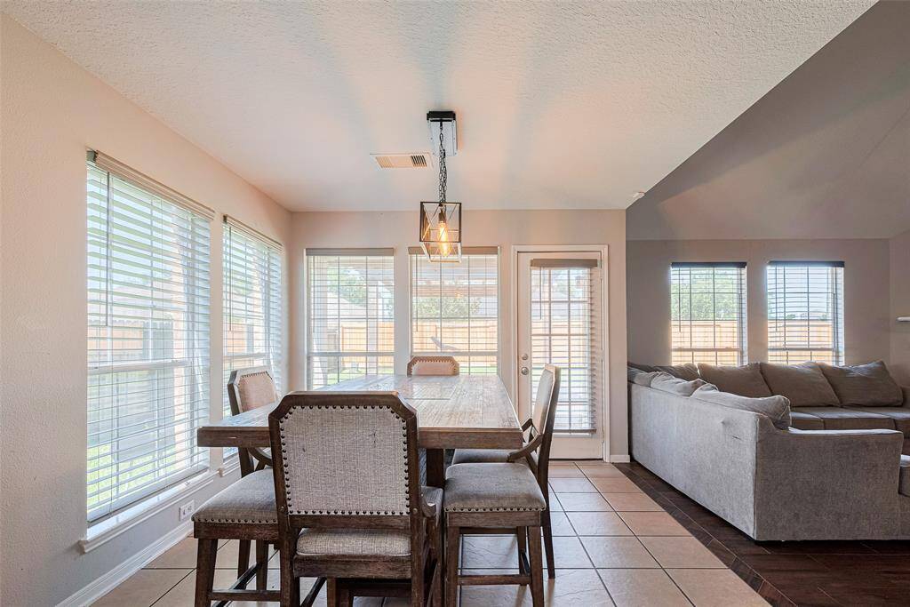 The dining room is bathed in natural light and is next to the kitchen and family room.