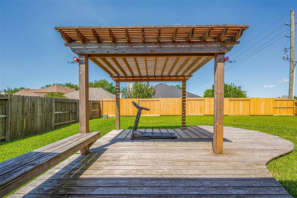 Play or rest in the lush backyard.  Enjoy the shade of the pergola.