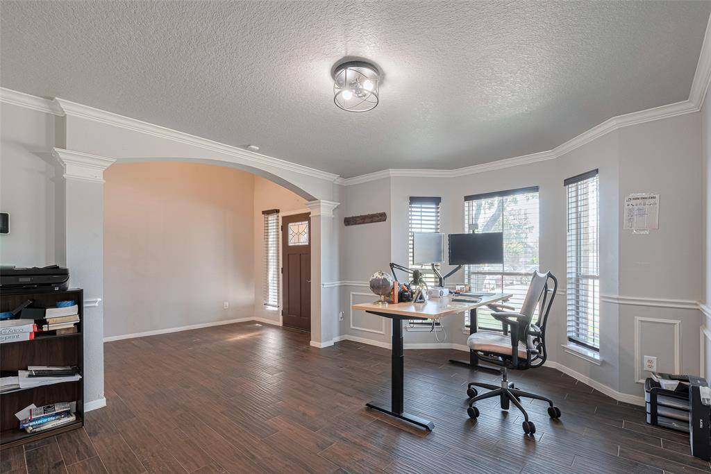 Near the entry is a room den - perfect for a home office or formal living room.
