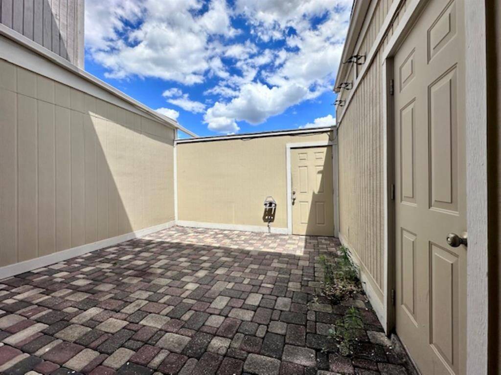 Back door leads to two covered parking spaces.