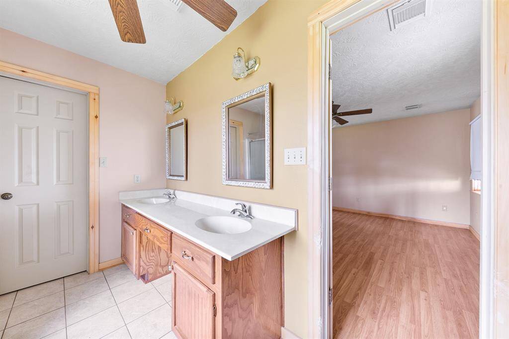 The primary bathroom is equipped with double sinks, providing ample space and convenience for daily routines.