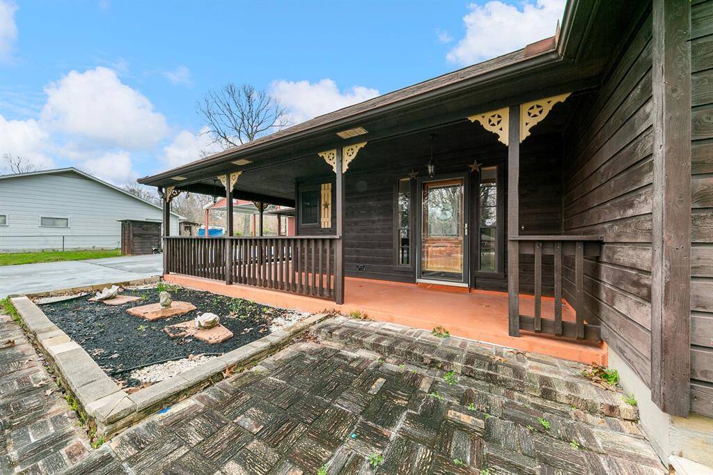 The covered front porch provides a welcoming entry with a shaded space to relax and enjoy the surroundings.