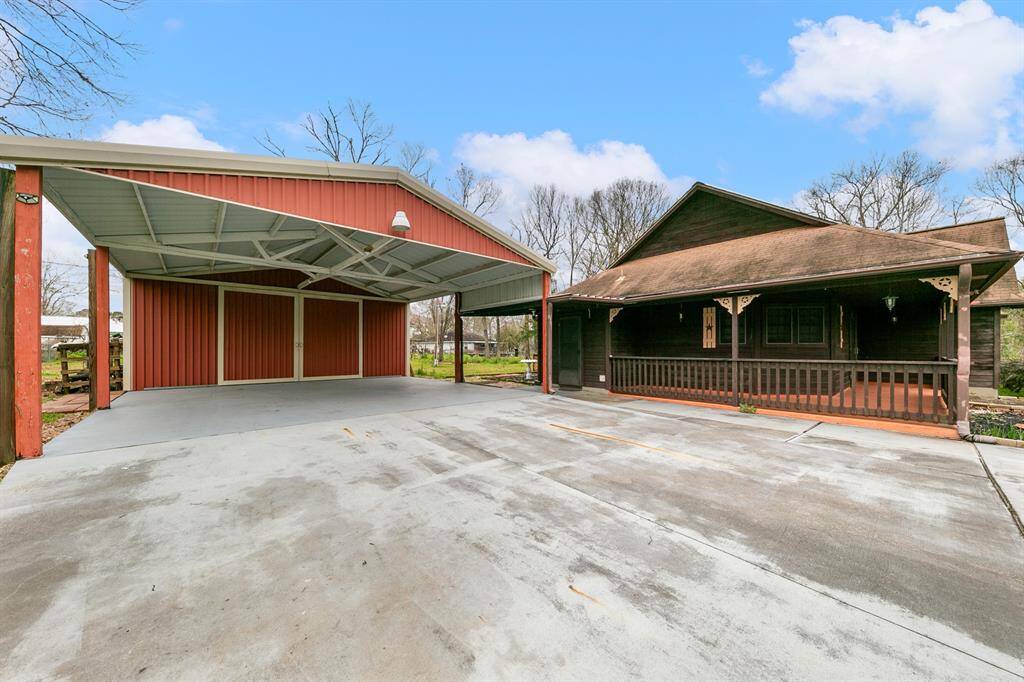 Spacious carport provides covered parking with ample room for vehicles, boats, or RVs, offering protection from the elements and additional storage options