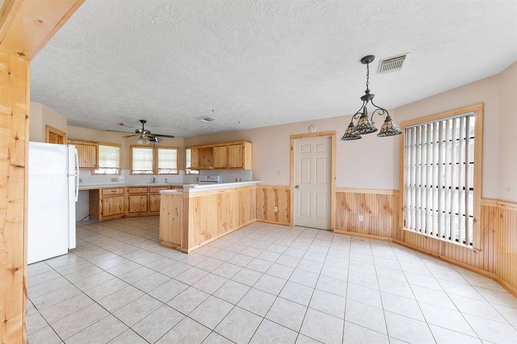The spacious eat-in kitchen offers plenty of room for a dining table, making it the perfect spot for casual meals and gatherings.