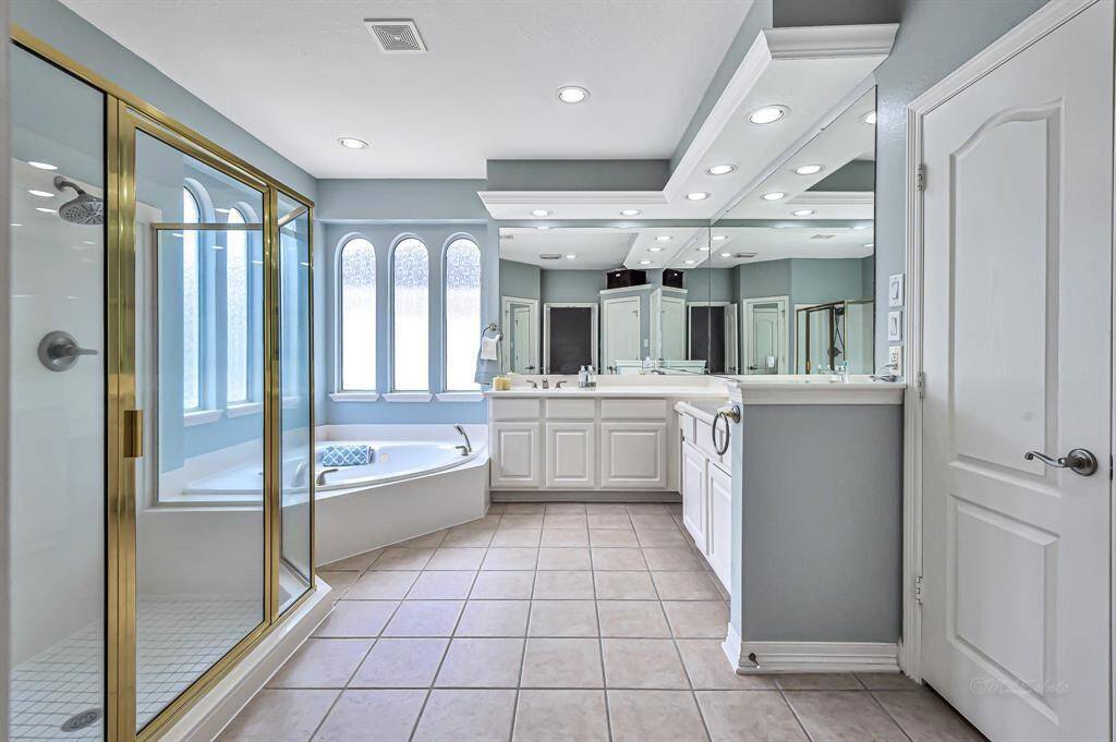 Master bath with walk-in shower and bath tub.
