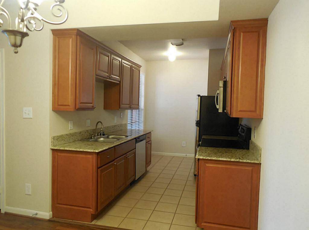 Kitchen could also fit a table or desk by the large window in the back