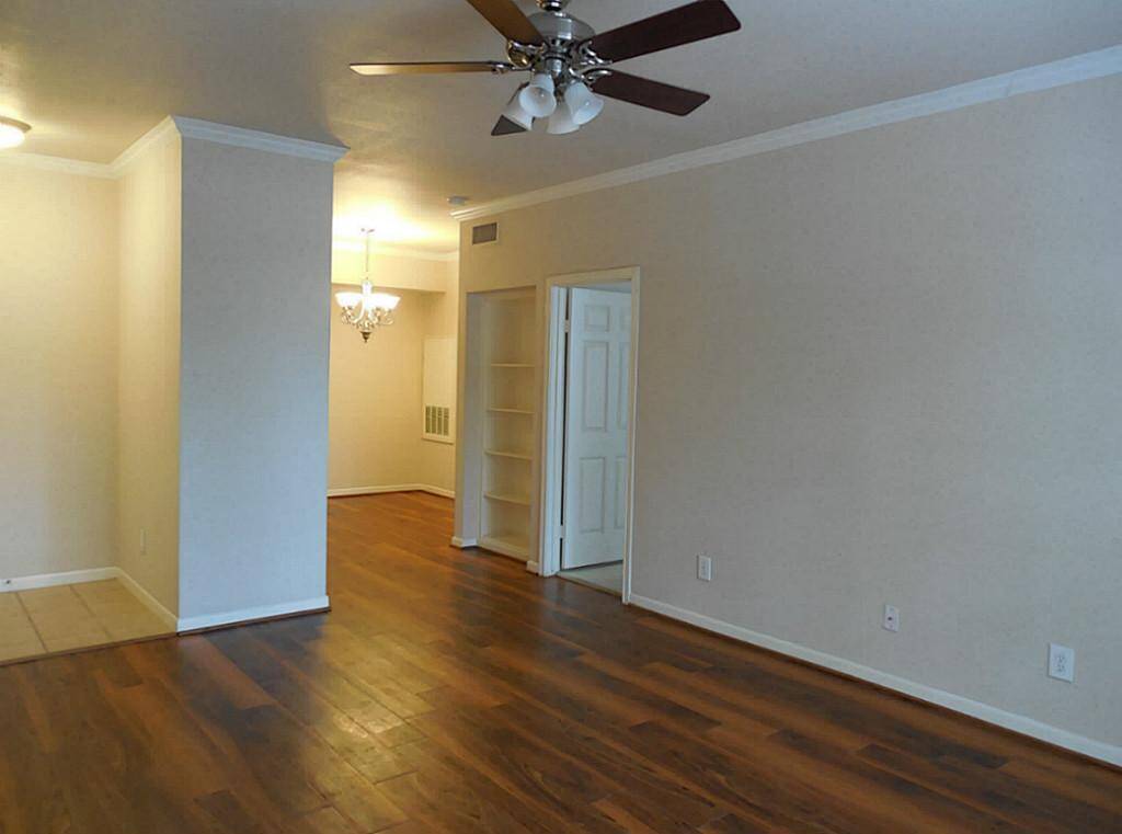 Open to dining with nice chandelier.  Entrance to the bedroom at right.