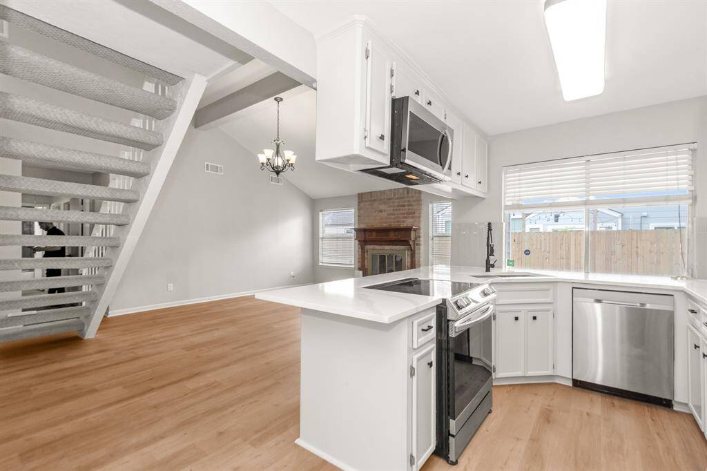 Enjoy views of the backyard porch from the kitchen window, bringing in natural light and a connection to the outdoor space.