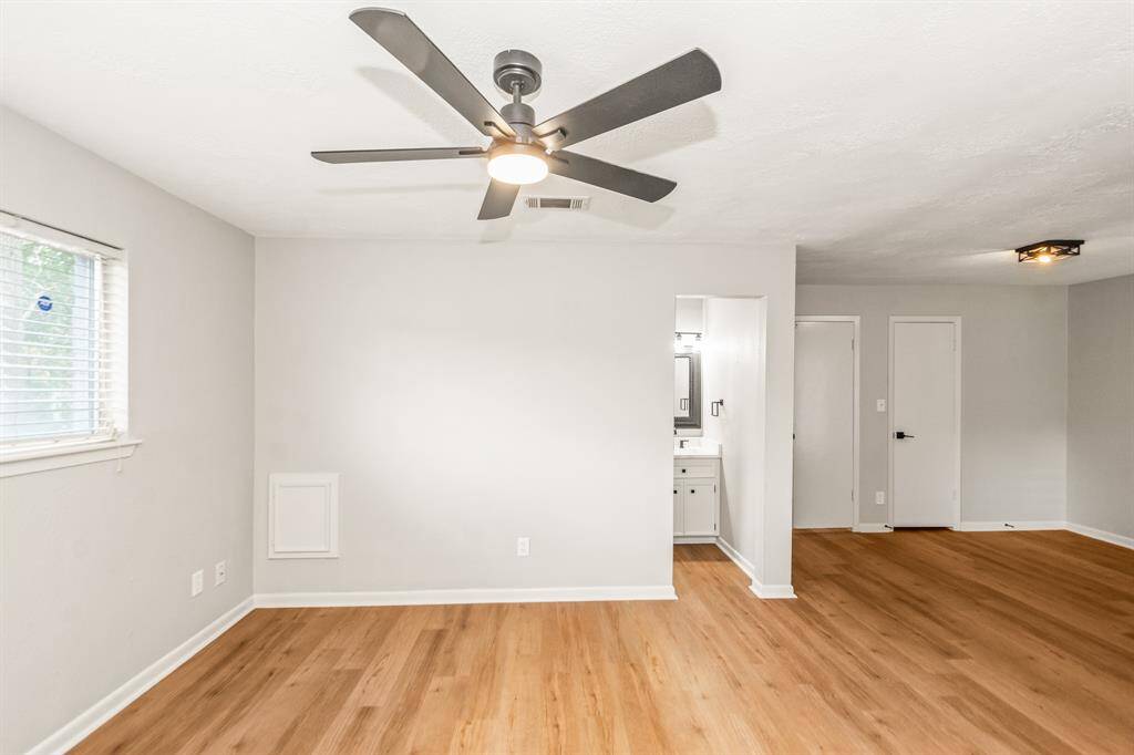 The primary bedroom offers wood-look luxury vinyl plank flooring, two generous closets, an ensuite bathroom, and is spacious enough to accommodate a sitting area.