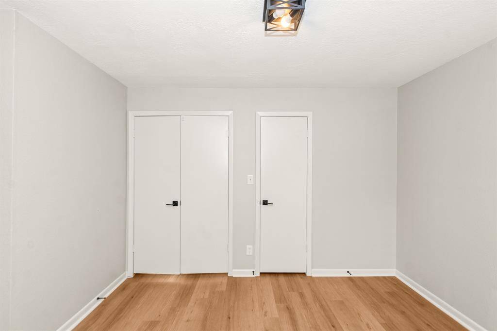 View of the double door entrance to the primary bedroom, with an additional closet to the right.