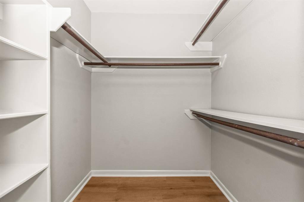 The primary bedroom walk-in closet, measuring 5x5, is equipped with built-in shelving for optimal organization and ample hanging space.