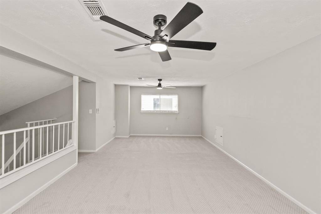 Spacious 24 x 13 upstairs flex room with views of the side yard.