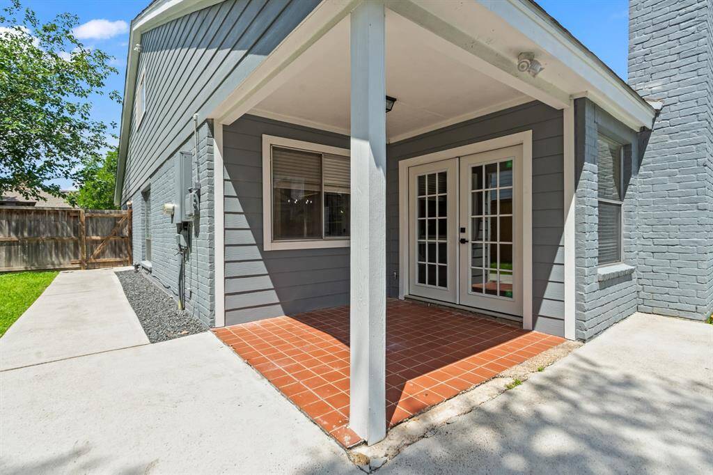 The covered back porch measures 7x7 and provides a cozy outdoor retreat with direct access to the living room through double French doors.