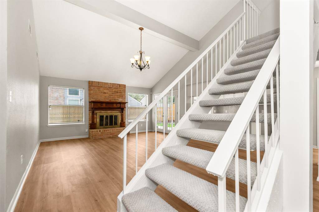 As you enter the home, you're greeted by a freshly carpeted staircase that leads up to the spacious upstairs loft.