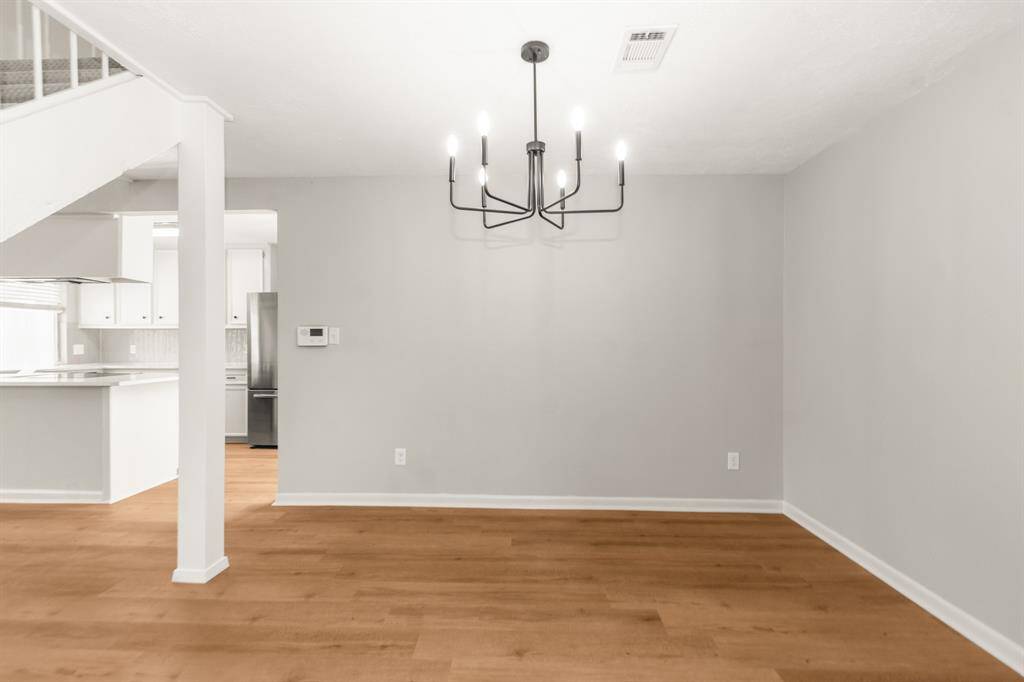 Open-concept dining space seamlessly connects to the kitchen, featuring brand new contemporary lighting and updated finishes throughout.