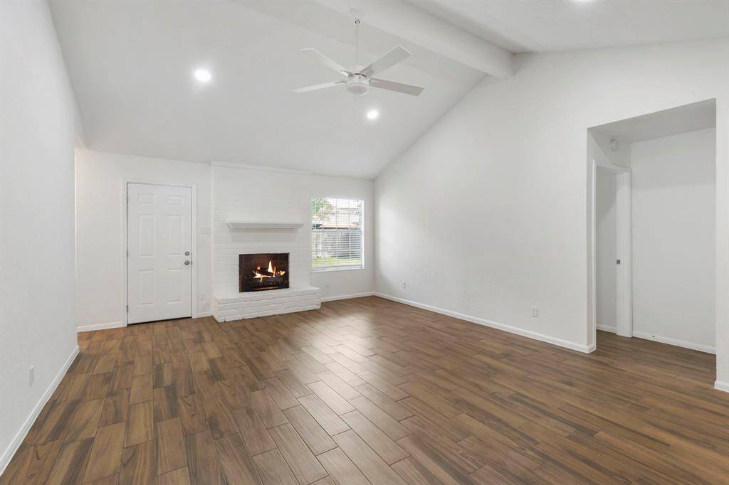 Living room with high ceilings and cozy fireplace.