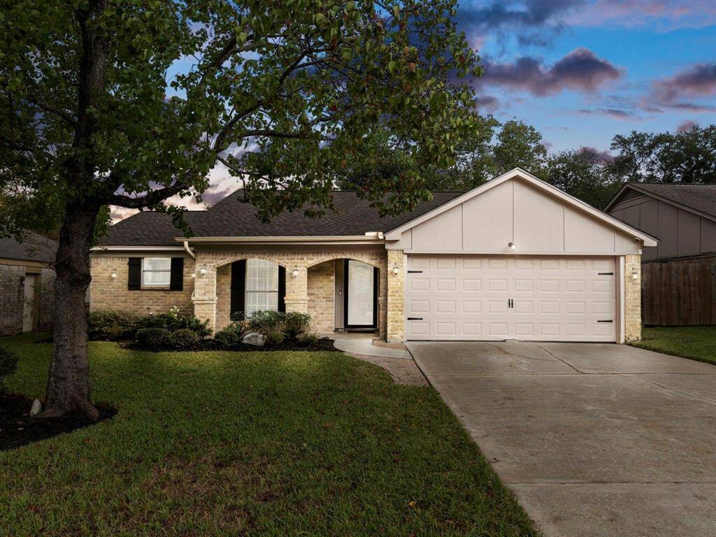 Freshly mulched yard with mature landscape.