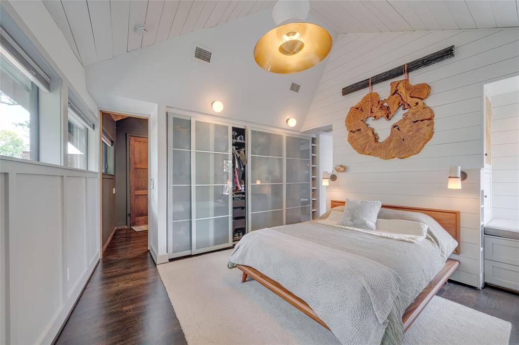 Another cozy nook in the Primary suite has a window inviting in the natural light, storage and a sitting area.
