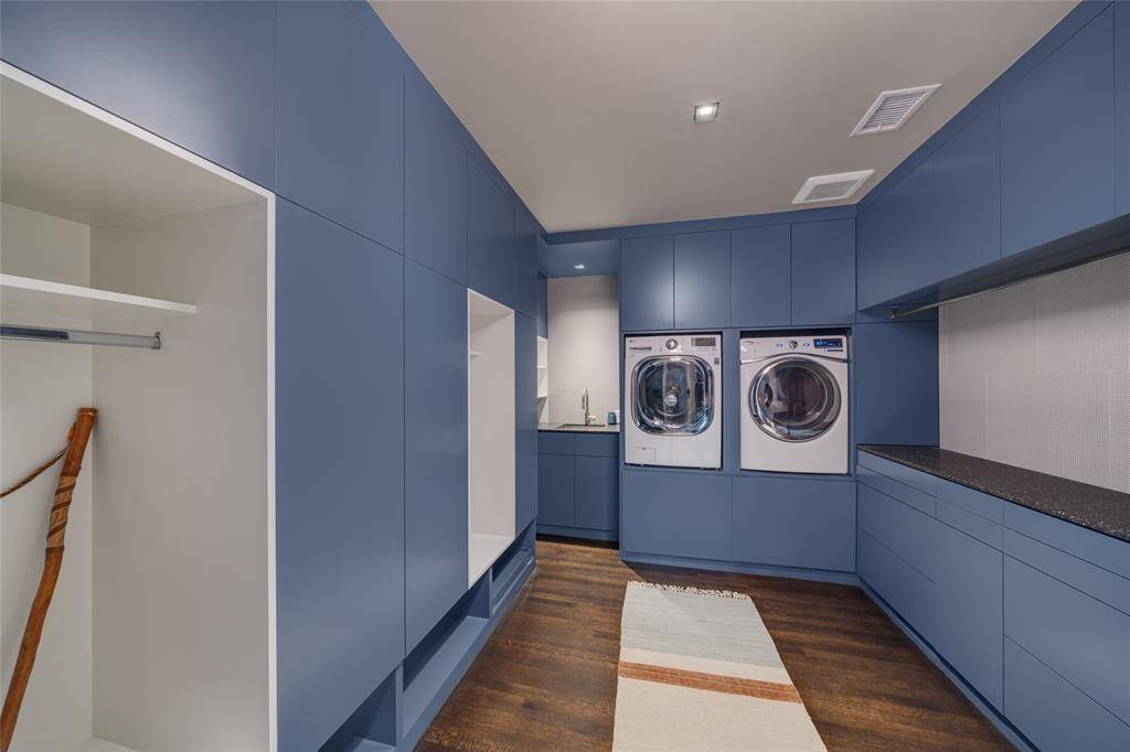 The laundry room/mudroom has covered and open cubby's for for storage. a counter to fold clothes. This room is very well thought out.