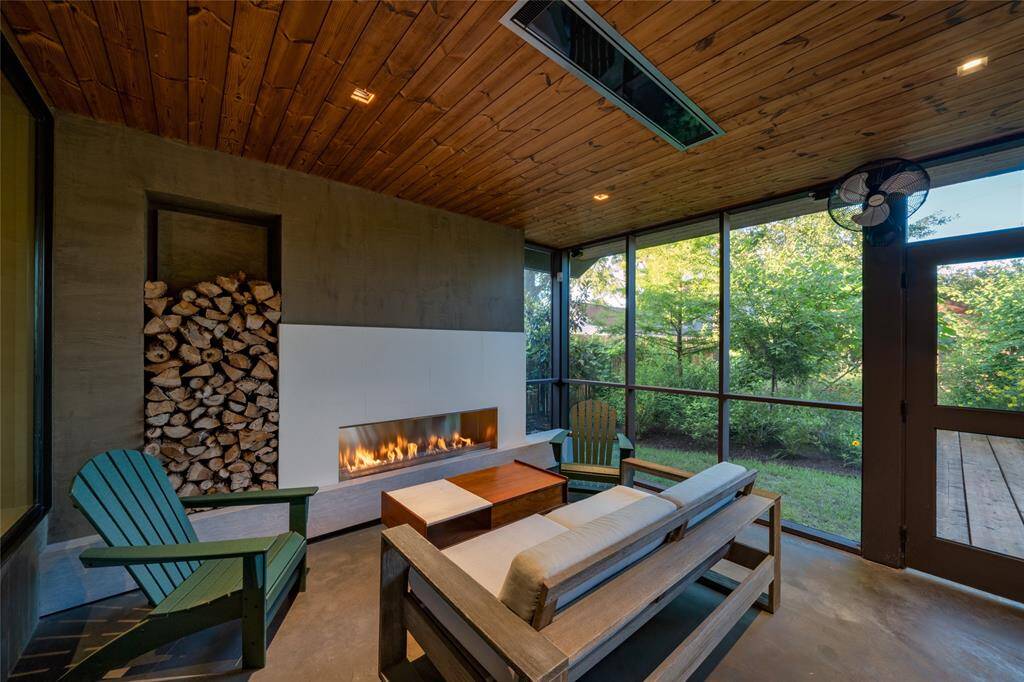 Experience ultimate relaxation in this essential screened porch, perfect for enjoying the outdoors year-round.