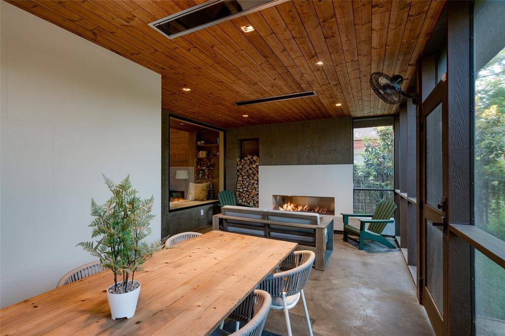 Cozy screened porch with a fireplace, perfect for family evenings.