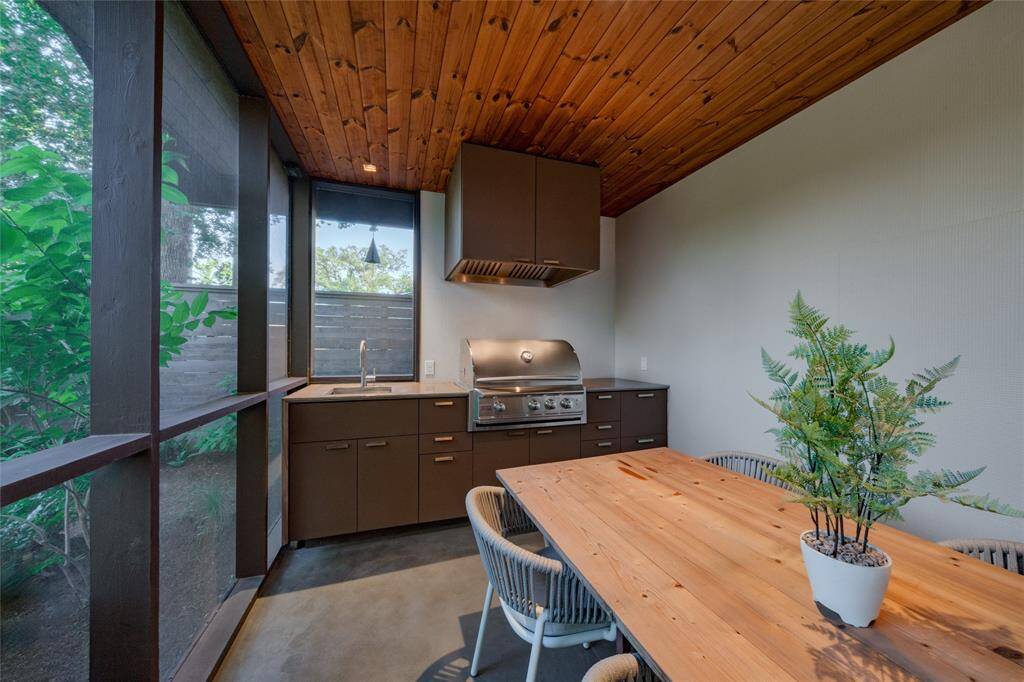 Experience seamless outdoor entertaining with a fully-equipped kitchen, featuring hot water and a convenient vent hood.