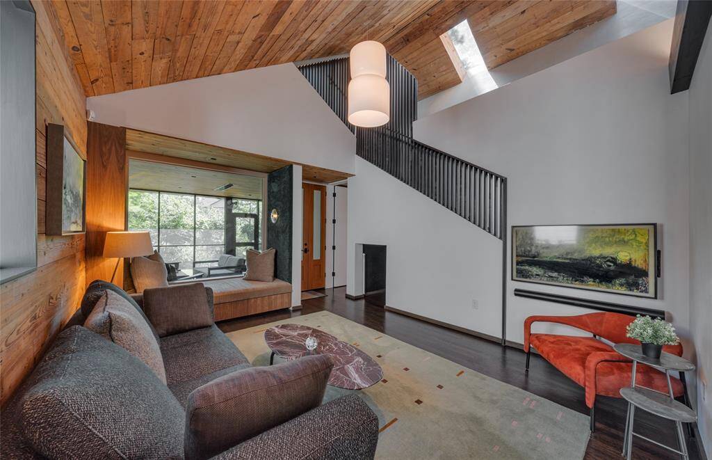 This living space is designed with a blend of wood, metal and glass to enjoy the comfort of home.