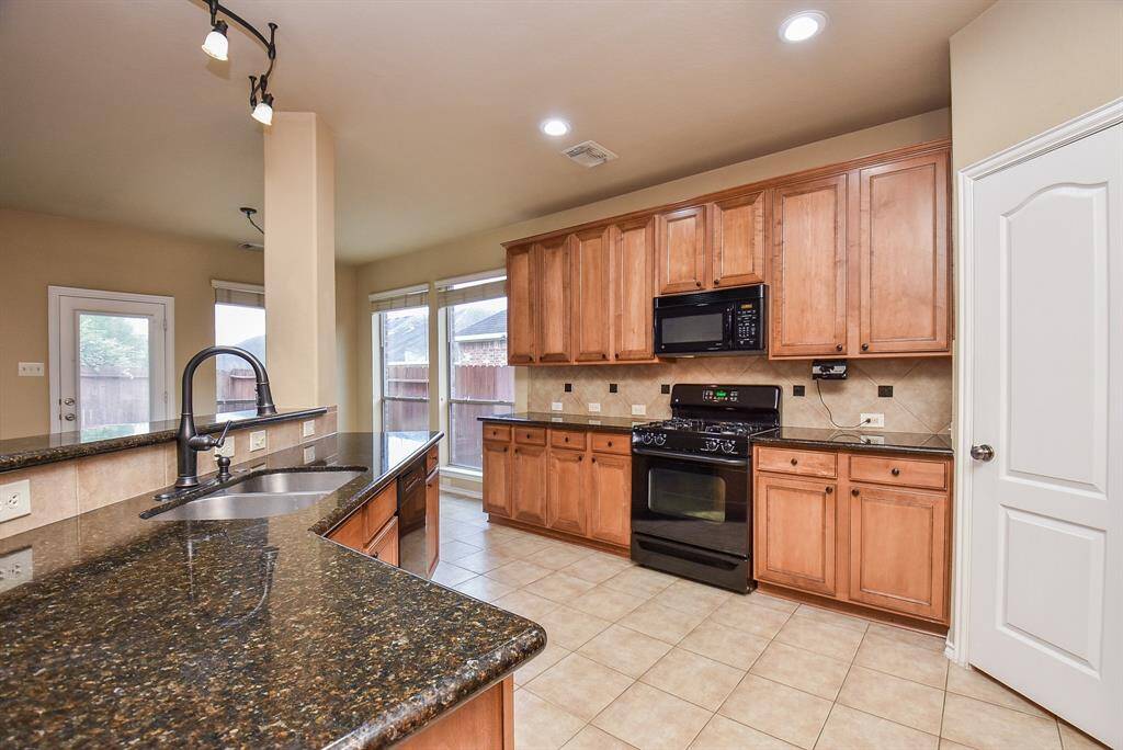 Kitchen with Granite counter gas range and ample cabinet space