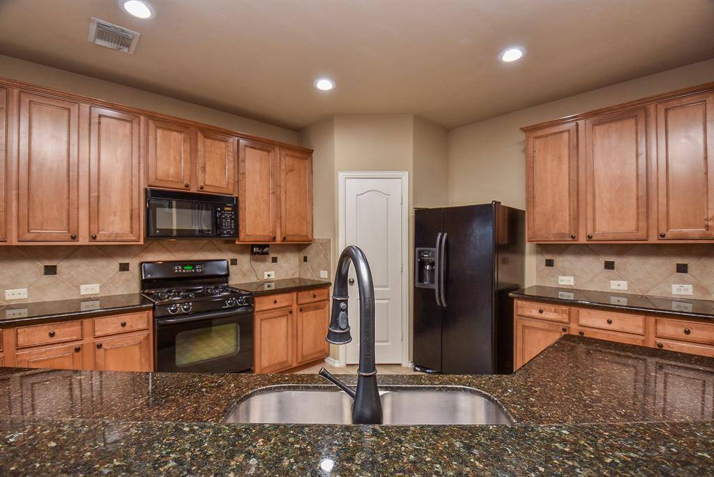 Kitchen with Granite counter gas range and ample cabinet space