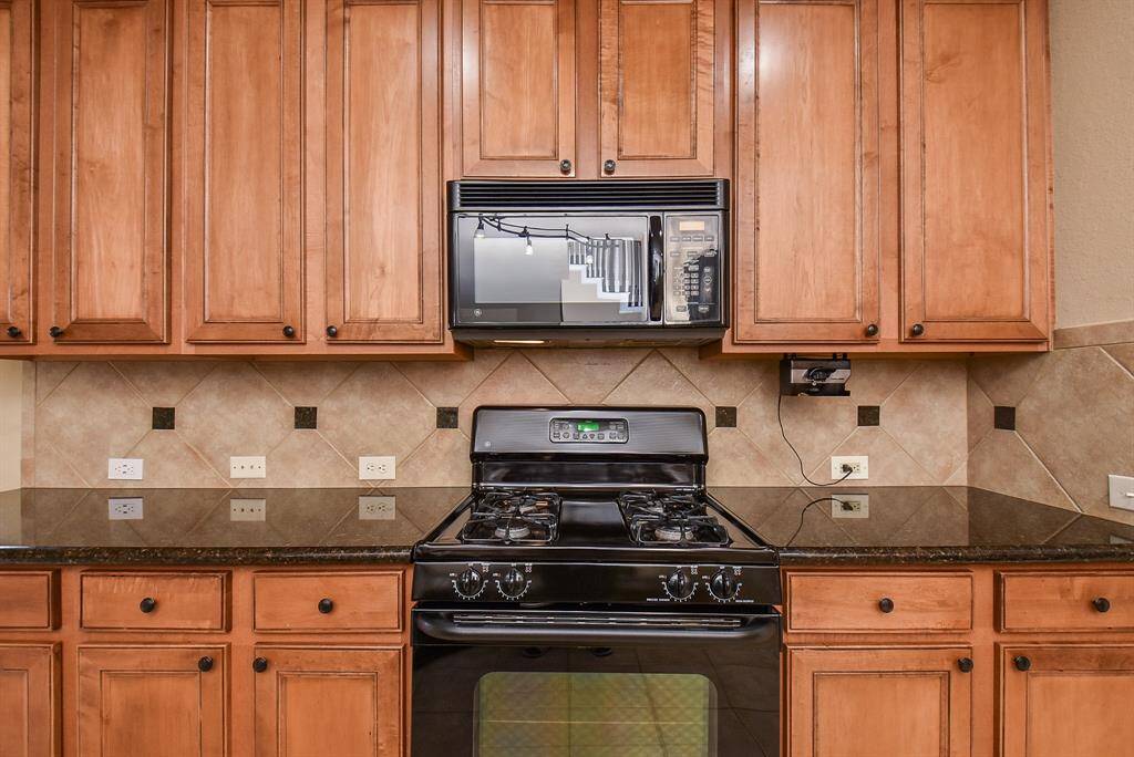 Kitchen with Granite counter gas range and ample cabinet space