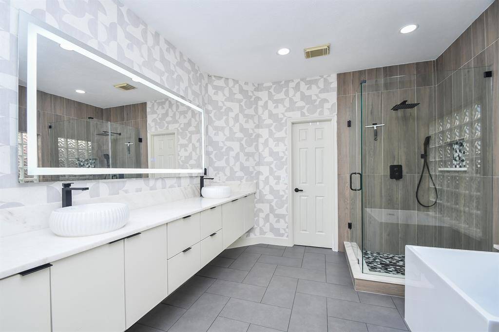 Primary bath remodeled (2023) with soft close cabinet, stone counters, lighted mirror