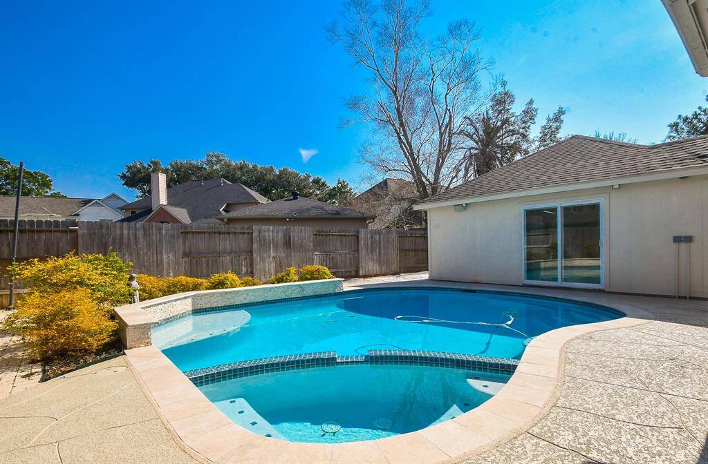 Remodeled garage has sliding doors opening to deck