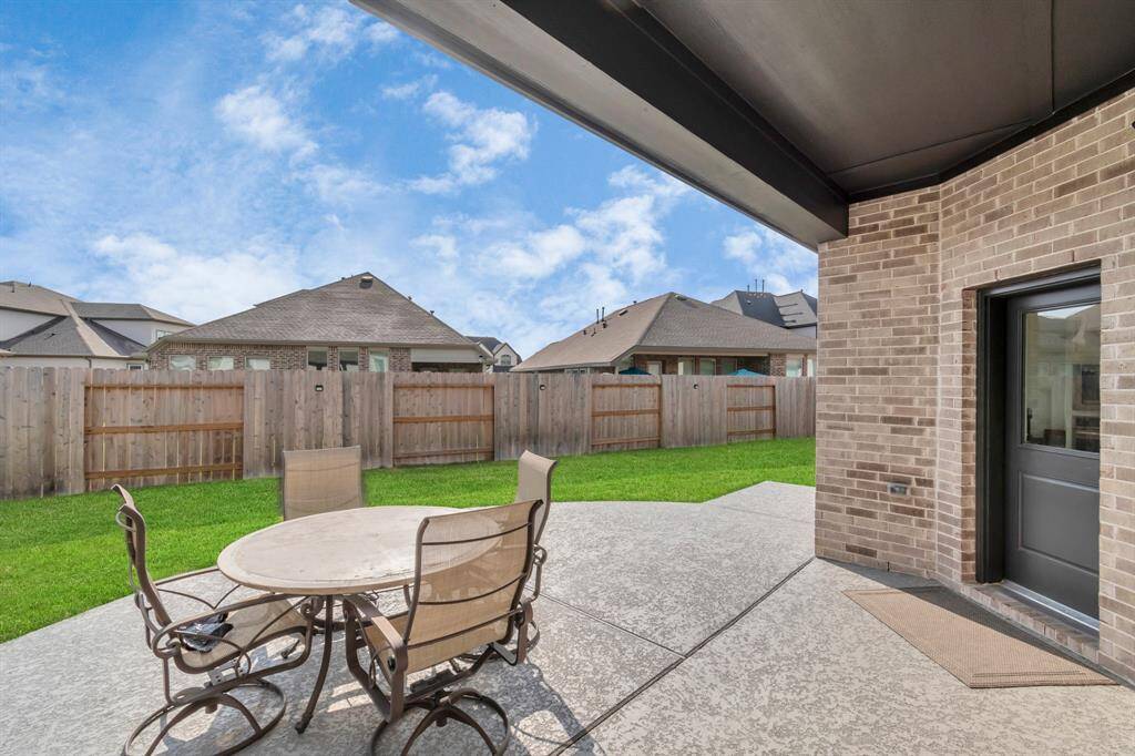The backyard is an ideal space for outdoor living, offering ample room for both relaxation and recreation, enhanced with upgraded concrete flatwork for added functionality and style.
