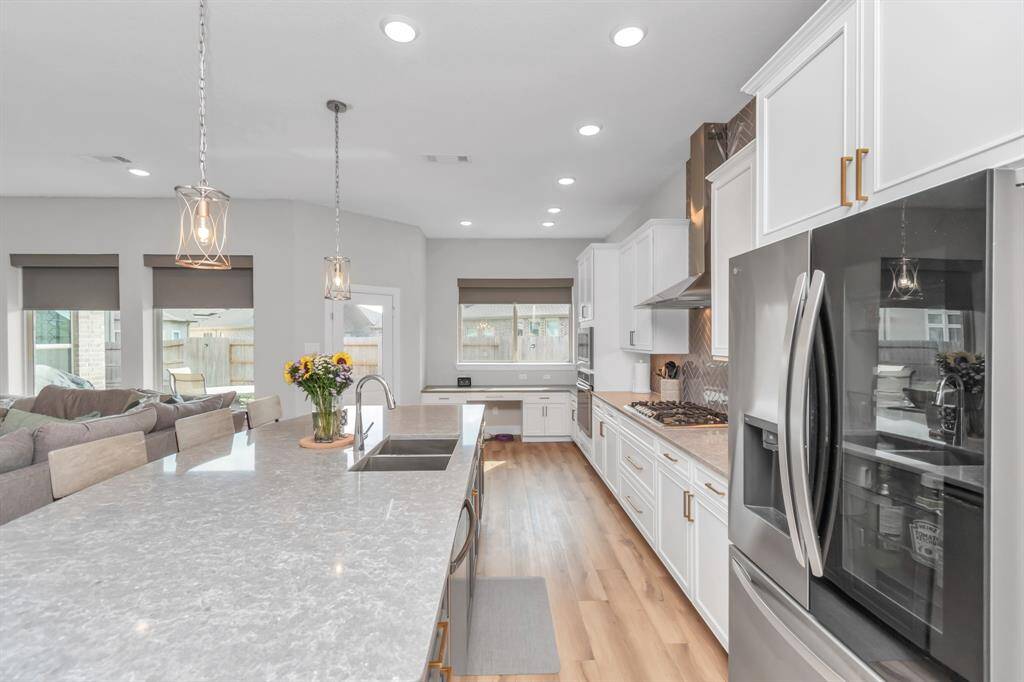 Neutral tones harmonize beautifully with the bright, open design of this upgraded kitchen, creating a warm and inviting atmosphere.