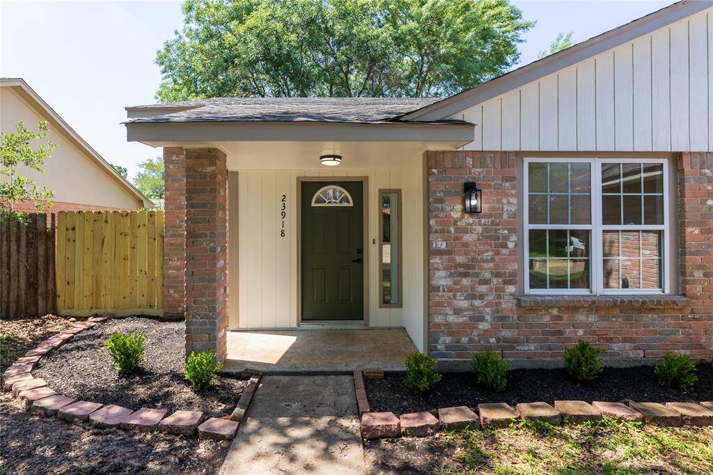 Freshly painted exterior with a new front door and new landscaping