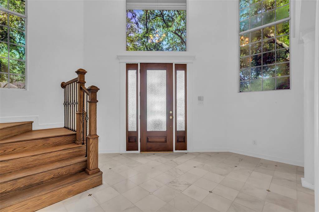 Elegant 2 story entry with marble entry, stairs leading to the bedrooms upstairs.