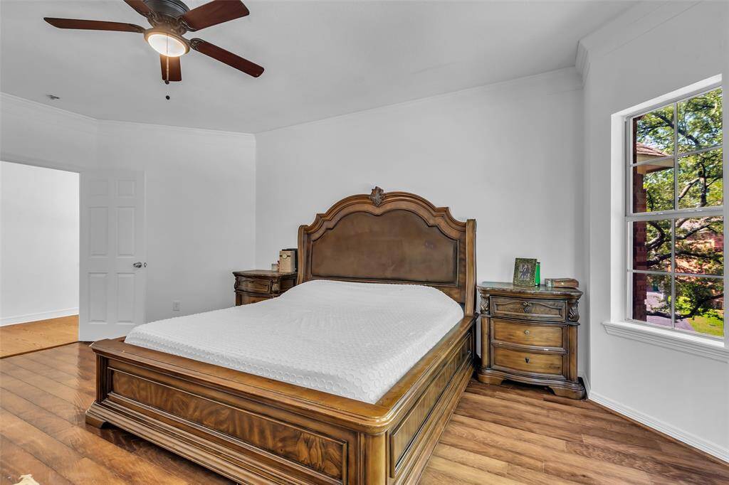 Primary bedroom at the top of the stairs.  New paint, new fan, lots of natural light....Ready for you to call it yours!