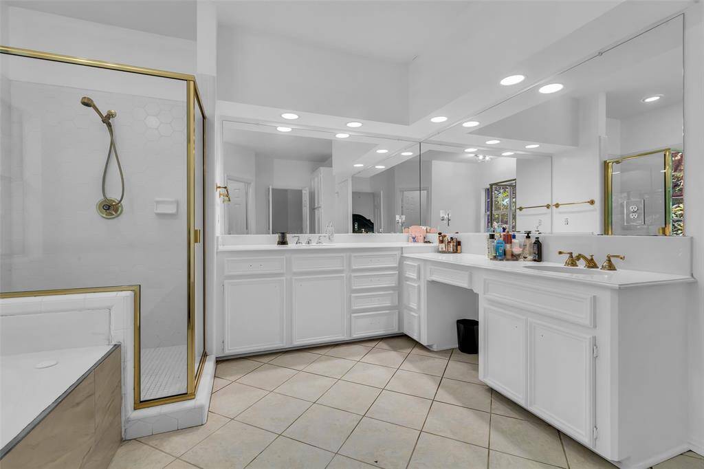 Primary bath has fresh bright paint, large stand along shower and lots of counter space  for both of you.  Makeup space for the lady!