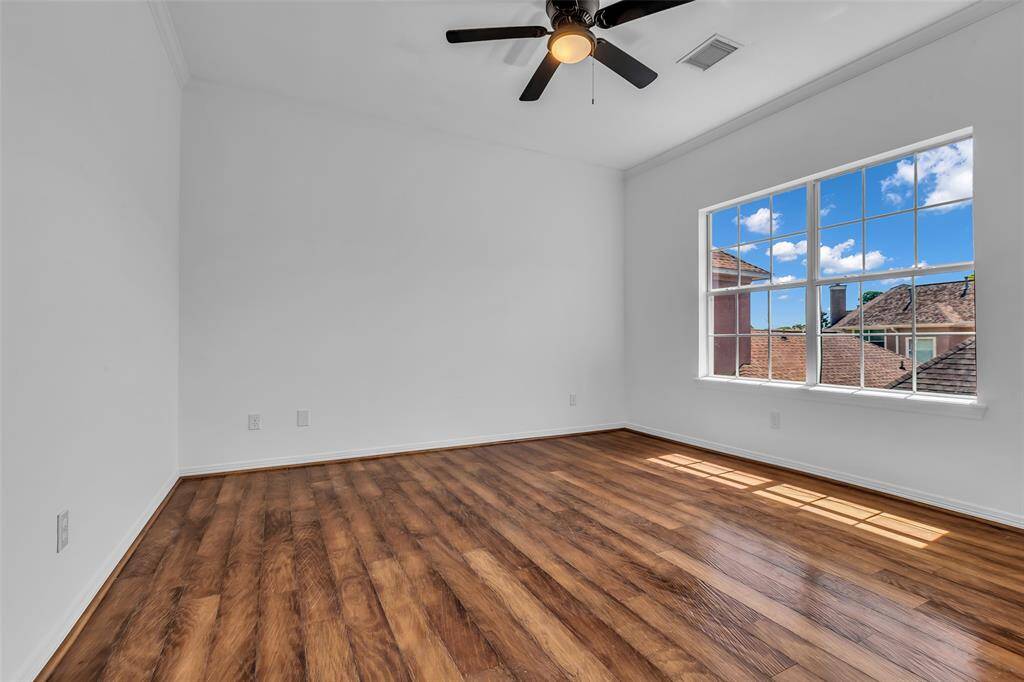 3rd bedroom upstairs, with elegant engineered wood flooring and large window.