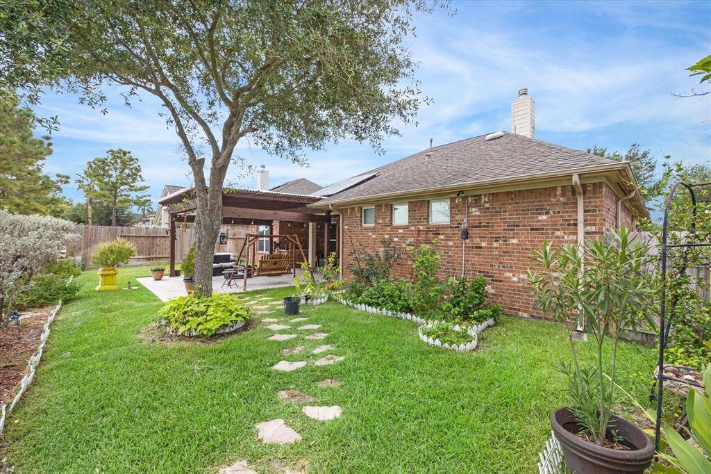 Covered patio, pergola and swing.  All brick on the back of the house.