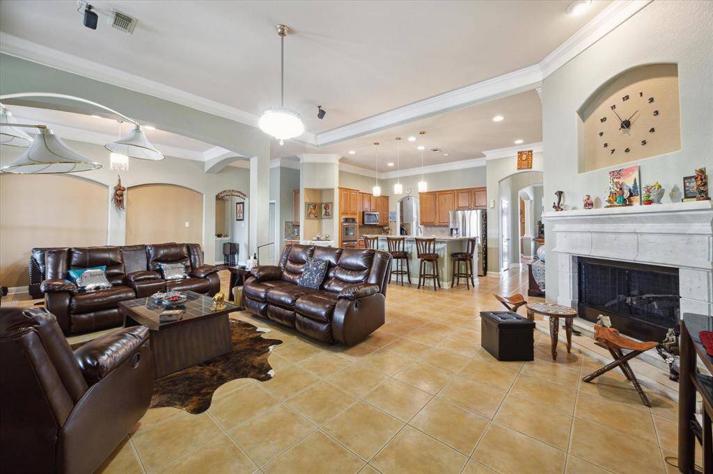 Living room with gas fire place, surrounding sound system, crystal light that opens into fan