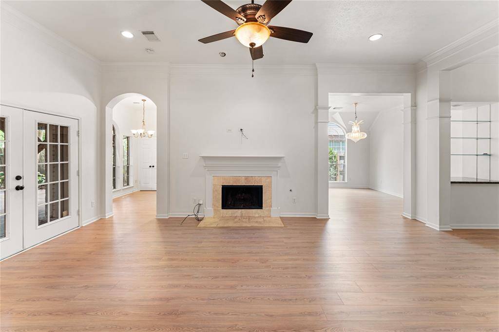 The living room is the center of the home and opens to the kitchen, dining room, and a dry bar.