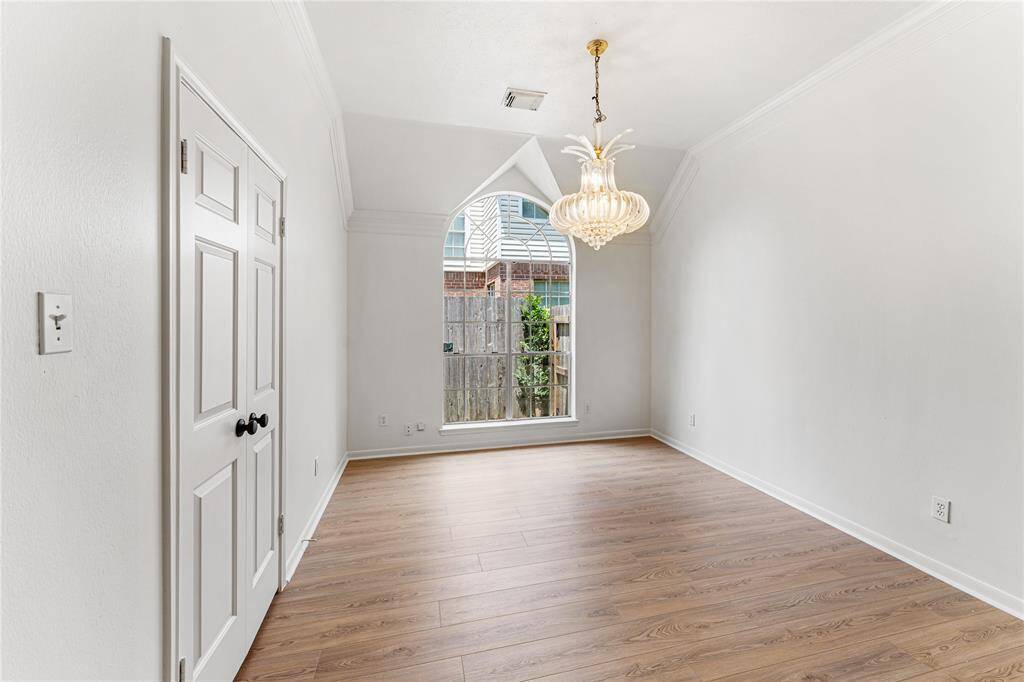 The dining room is perfect for entertaining, with a double door opening to the kitchen and a dry bar.
