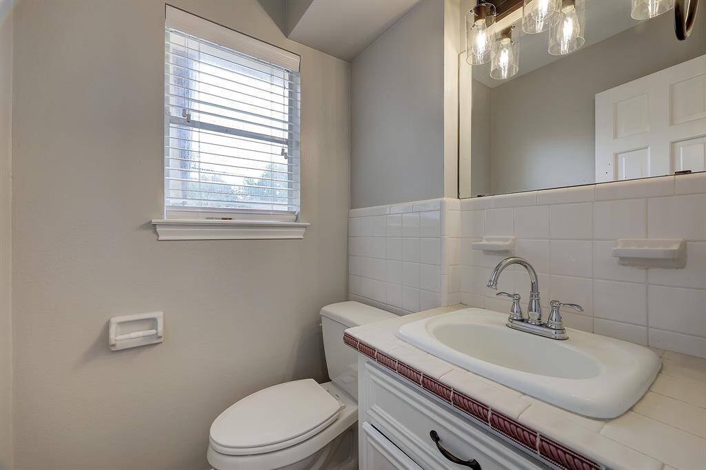 Attached laundry room, right off of the kitchen with an additional refrigerator and half bath