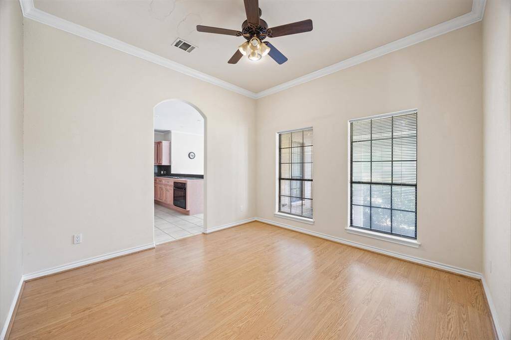 Formal dining with crown molding & arched doorways
