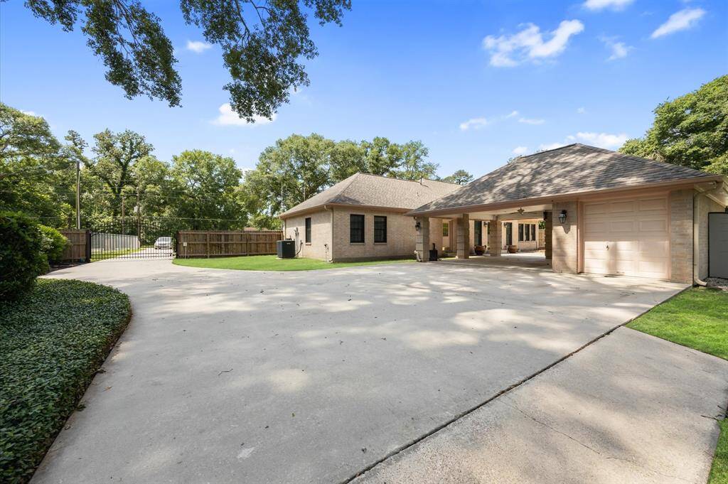 Gated driveway with carport & utility garage