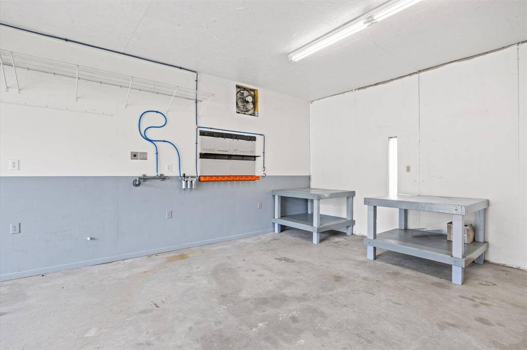 Workshop features air compressor lines & an office area equipped with a/c