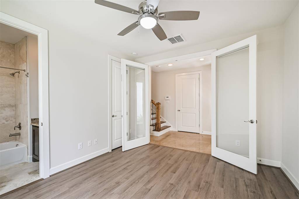 First floor bedroom with doors facing foyer