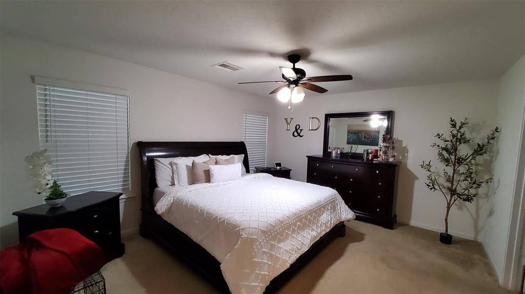 A spacious and inviting master bedroom,  designed for ultimate comfort and relaxation.