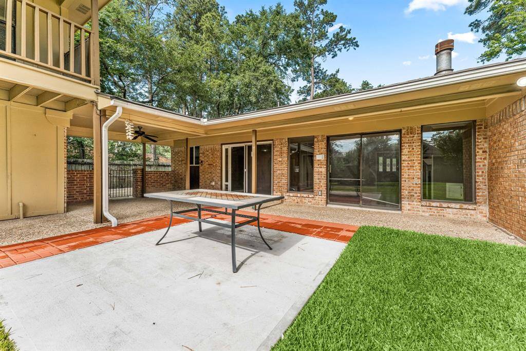 This photo shows the home connecting to the detached oversized garage, patio and gutters.